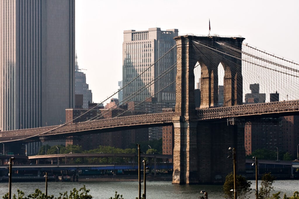 The Brooklyn Bridge And Manhattan New York City Skyline Near Dusk